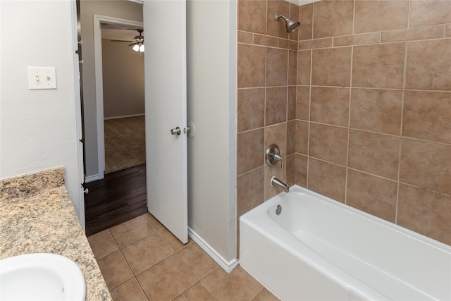 full bathroom with tile patterned floors, a ceiling fan, a sink, baseboards, and bathing tub / shower combination