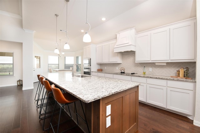 7409 Autumn Grove Ln, Ponder, TX 76259 - kitchen with custom range hood, crown molding, stainless steel oven, decorative backsplash, and built in microwave