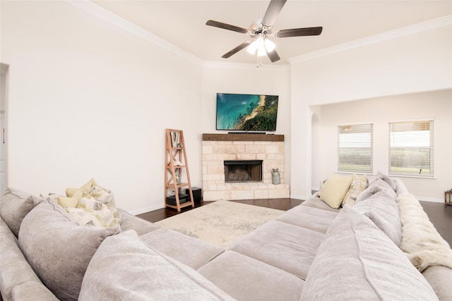 7409 Autumn Grove Ln, Ponder, TX 76259 - living area featuring crown molding, a ceiling fan, baseboards, a stone fireplace, and wood finished floors