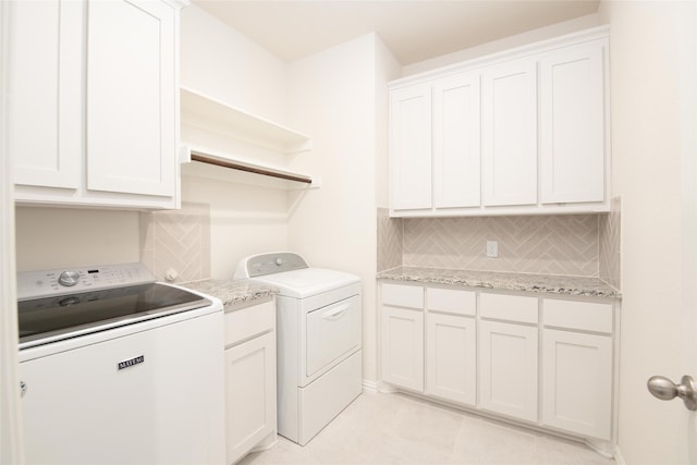 7409 Autumn Grove Ln, Ponder, TX 76259 - laundry area featuring washer and clothes dryer, cabinet space, and light tile patterned floors