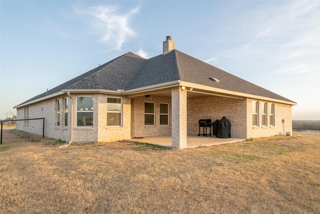 7409 Autumn Grove Ln, Ponder, TX 76259 - back of property featuring brick siding, a chimney, a patio area, and roof with shingles