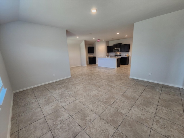 unfurnished living room featuring light tile patterned flooring, recessed lighting, and baseboards