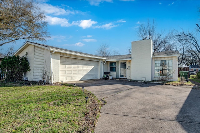 ranch-style home featuring brick siding, a front lawn, concrete driveway, a chimney, and an attached garage