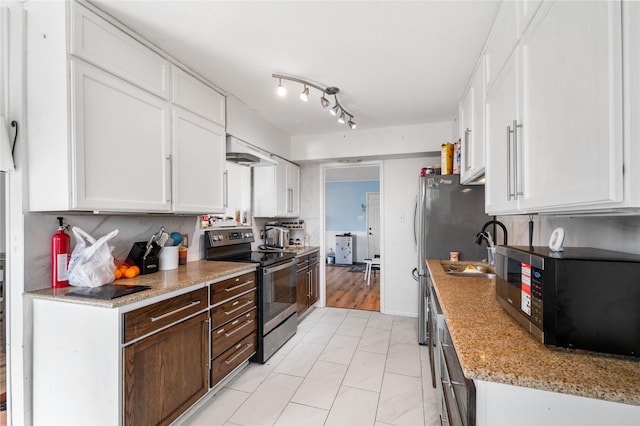 kitchen featuring under cabinet range hood, dark brown cabinetry, stainless steel appliances, white cabinetry, and a sink