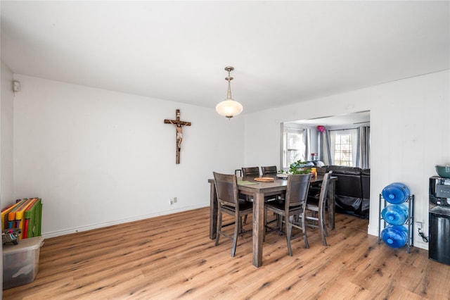 dining area featuring wood finished floors and baseboards