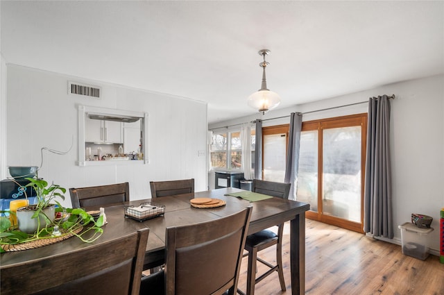 dining area with visible vents and light wood finished floors