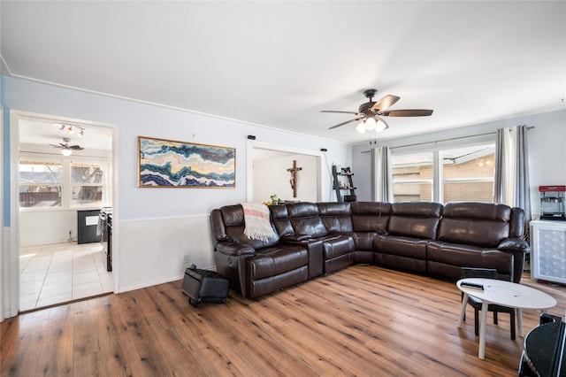 living room with wood finished floors and a ceiling fan