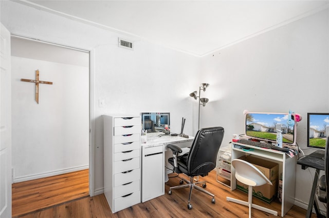 office area with wood finished floors and visible vents