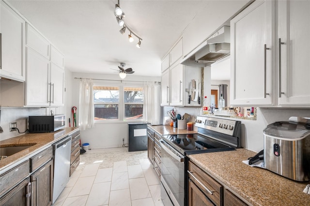 kitchen with under cabinet range hood, stainless steel appliances, white cabinets, and a sink