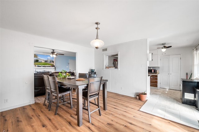 dining room featuring a wealth of natural light, visible vents, and light wood finished floors