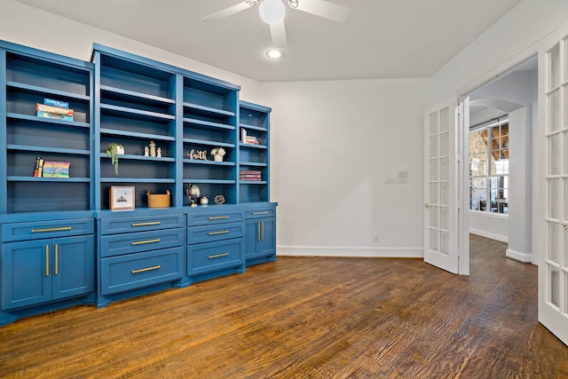 unfurnished office featuring baseboards, french doors, arched walkways, dark wood-style floors, and a ceiling fan