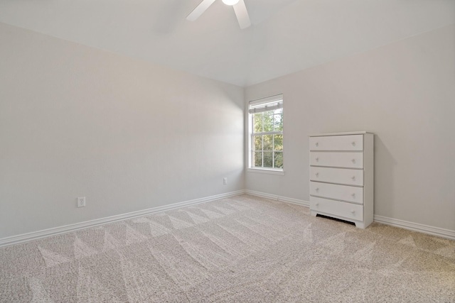 empty room with a ceiling fan, baseboards, and carpet floors