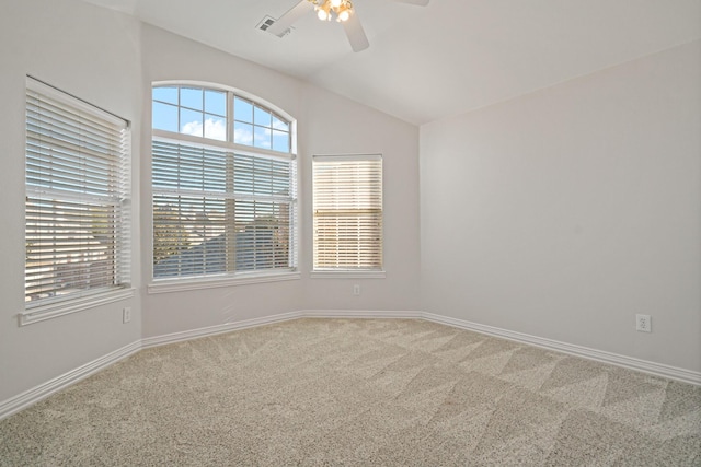 spare room featuring visible vents, a ceiling fan, carpet flooring, baseboards, and vaulted ceiling