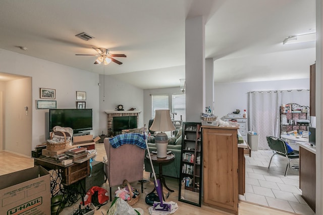 living area featuring visible vents and ceiling fan