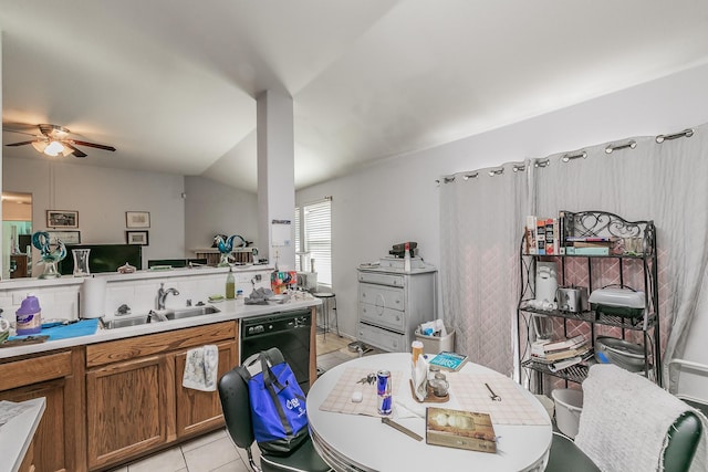 kitchen with brown cabinetry, lofted ceiling, a sink, light countertops, and dishwasher