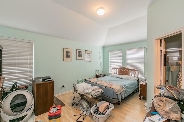 bedroom featuring wood finished floors and vaulted ceiling