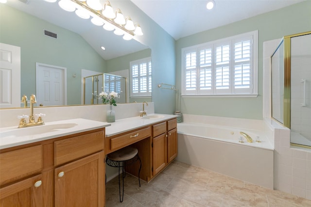 bathroom featuring visible vents, a shower stall, a garden tub, and a sink