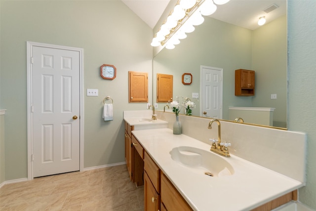 full bath with double vanity, visible vents, vaulted ceiling, and a sink