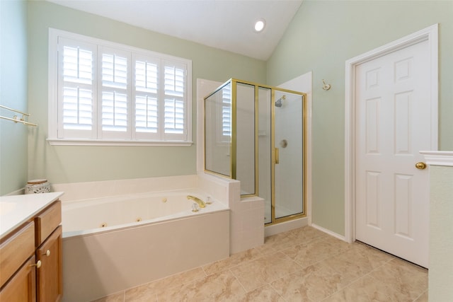 full bath featuring a jetted tub, vaulted ceiling, a stall shower, tile patterned floors, and vanity