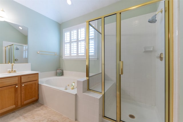 bathroom featuring vanity, a shower stall, a bath, and tile patterned floors