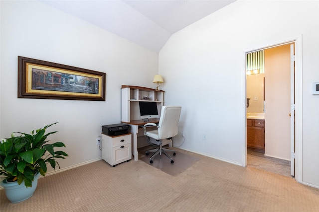 office with light colored carpet, baseboards, and vaulted ceiling