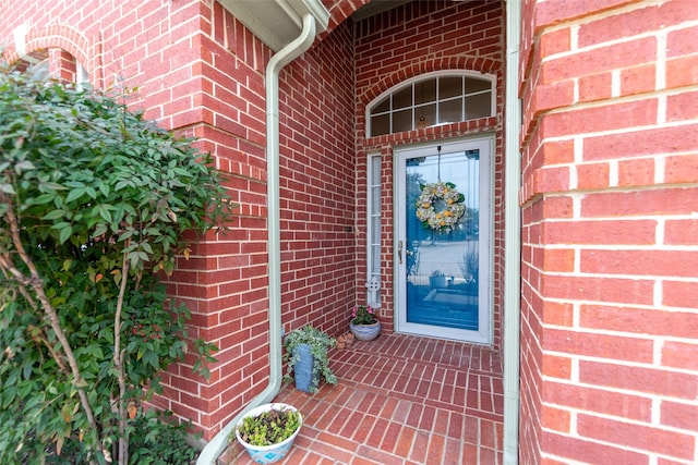 entrance to property with brick siding