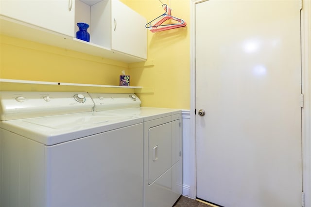 washroom featuring cabinet space and independent washer and dryer