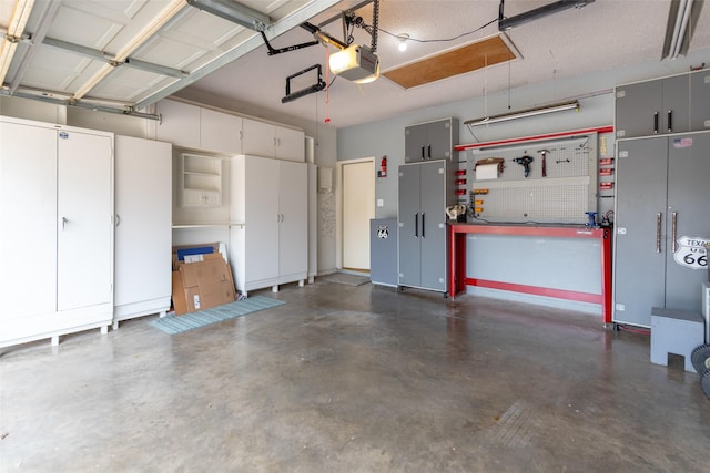 garage with a workshop area and a garage door opener