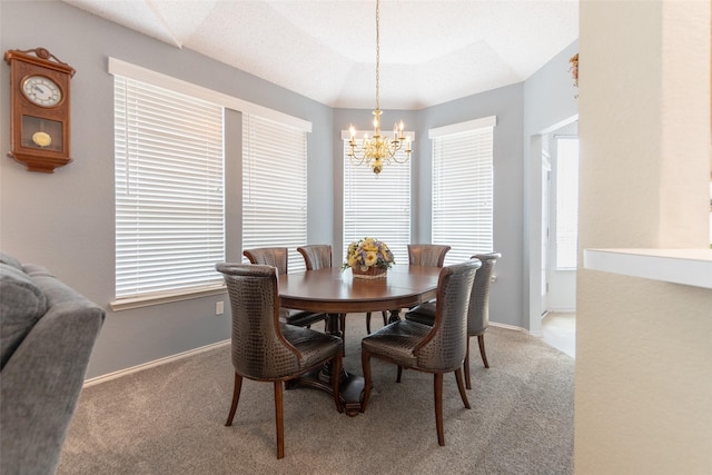 dining space with baseboards, a chandelier, and light carpet