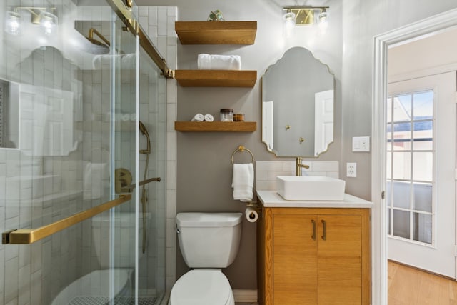 full bathroom with a shower stall, toilet, and vanity