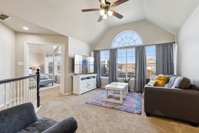 living area featuring visible vents, baseboards, lofted ceiling, light colored carpet, and ceiling fan