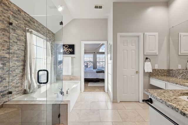 bathroom with visible vents, a shower stall, lofted ceiling, a bath, and vanity