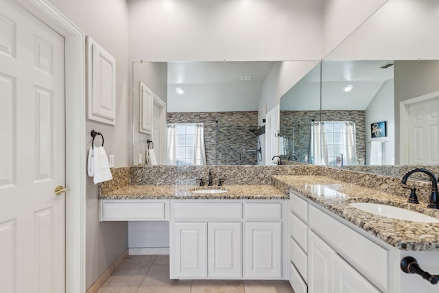 full bathroom featuring plenty of natural light, a shower stall, and a sink