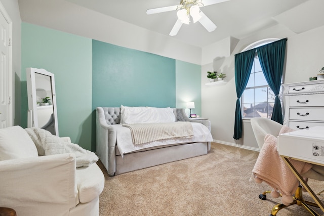 carpeted bedroom featuring baseboards and ceiling fan