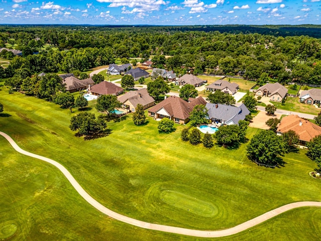 bird's eye view with a forest view, a residential view, and view of golf course