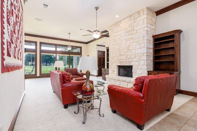 living area featuring a stone fireplace, baseboards, visible vents, and ornamental molding