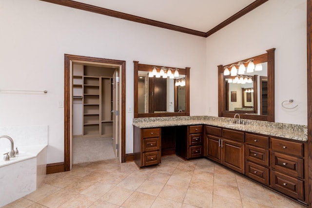 full bathroom with a walk in closet, baseboards, crown molding, a garden tub, and vanity