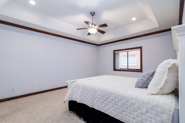 bedroom with a tray ceiling, recessed lighting, baseboards, light colored carpet, and ceiling fan