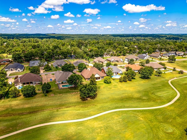 birds eye view of property with a forest view, a residential view, and view of golf course