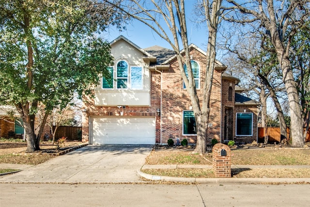 traditional-style house featuring brick siding, concrete driveway, and fence