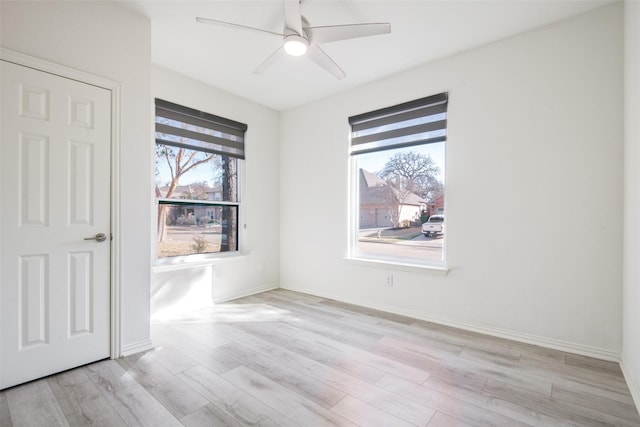 unfurnished room with light wood-style flooring, baseboards, and ceiling fan