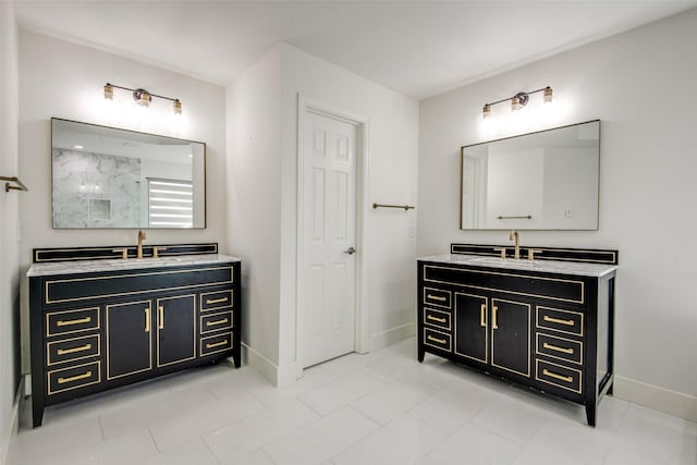 full bathroom featuring a sink, a shower, baseboards, and two vanities