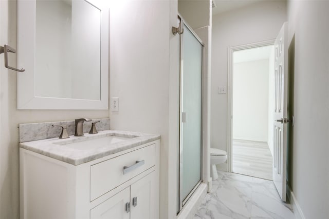 bathroom featuring toilet, marble finish floor, a shower stall, baseboards, and vanity