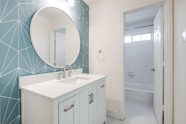 full bath featuring baseboards, vanity, and tile patterned flooring