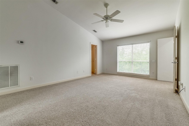 empty room with baseboards, visible vents, and light carpet