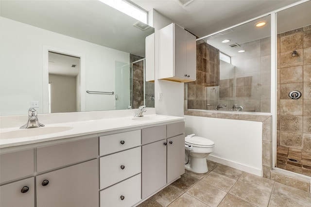 bathroom with a shower stall, double vanity, and a sink