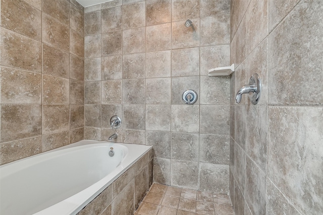 bathroom with tiled tub and a tile shower