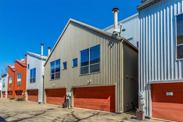 exterior space with a garage, a residential view, and board and batten siding