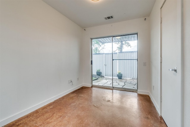 empty room featuring visible vents, baseboards, and concrete flooring