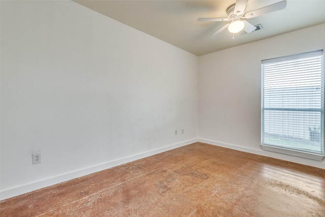 unfurnished room with a wealth of natural light, concrete flooring, and baseboards